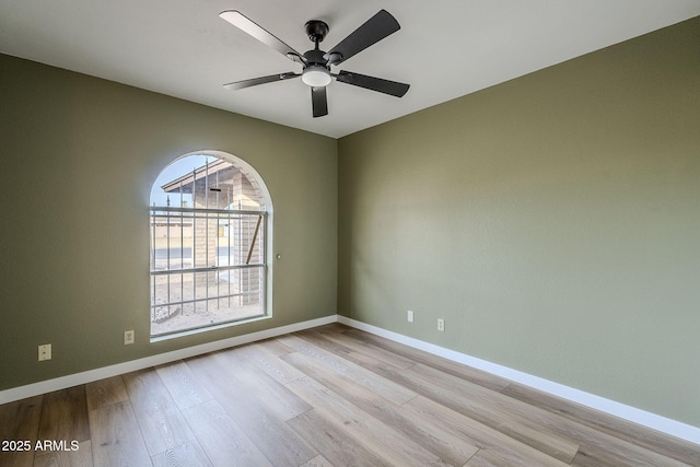 empty room with ceiling fan and light hardwood / wood-style floors