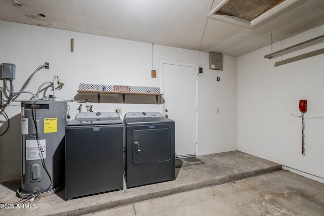 clothes washing area featuring separate washer and dryer and water heater