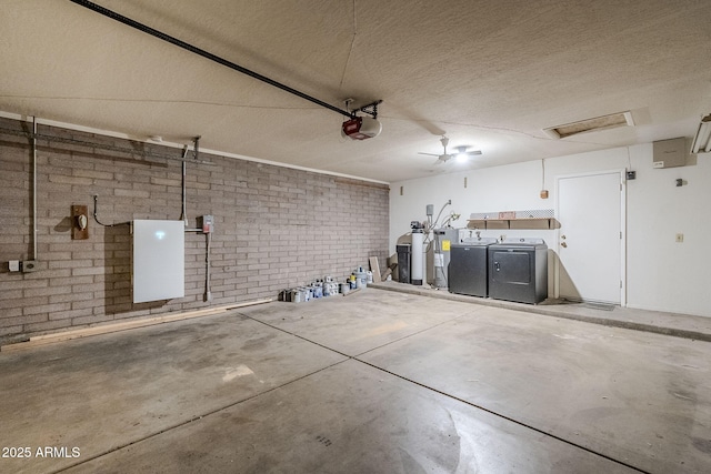 garage with separate washer and dryer and a garage door opener