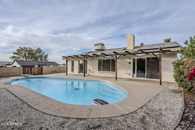 view of swimming pool with a patio, central AC unit, and a diving board