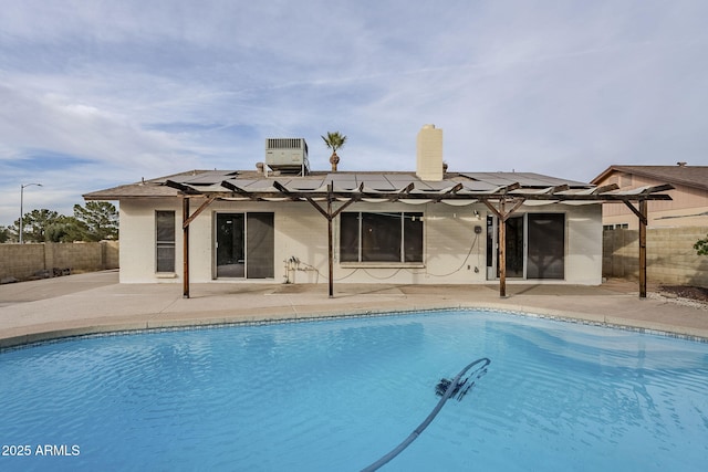 back of property featuring a pergola, a fenced in pool, a patio, and central AC unit