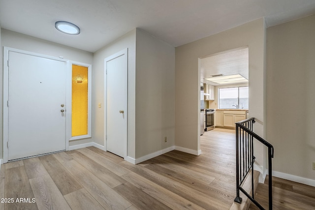 entryway featuring light hardwood / wood-style floors and sink