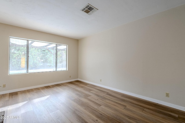 unfurnished room with light hardwood / wood-style flooring