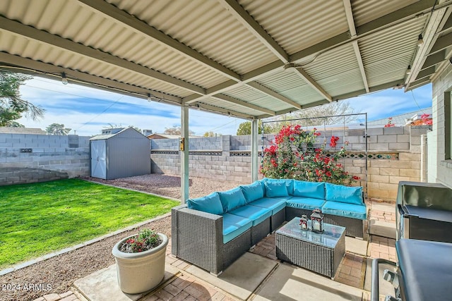 view of patio / terrace with an outdoor hangout area and a storage shed