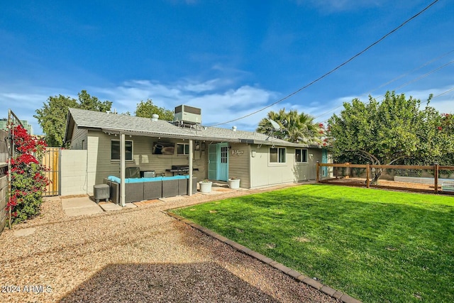 back of property with an outdoor hangout area, central AC, and a lawn