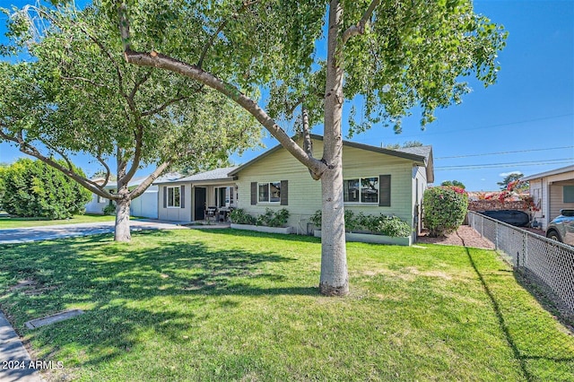 ranch-style home with a front lawn