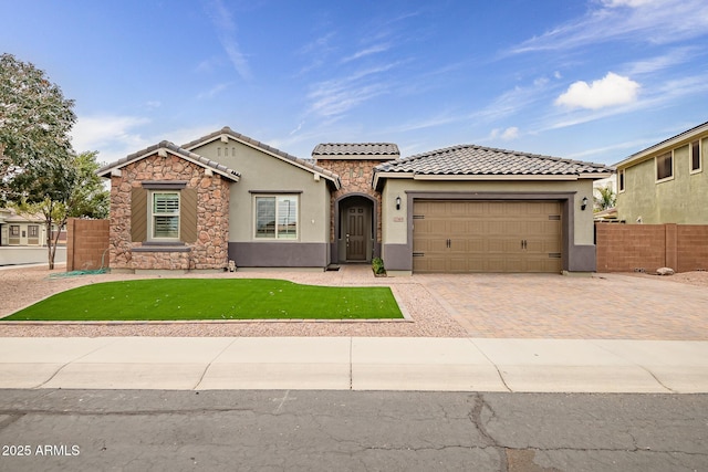 mediterranean / spanish-style home featuring a front yard and a garage