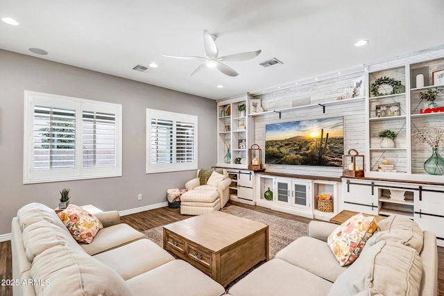 living room featuring hardwood / wood-style flooring and ceiling fan