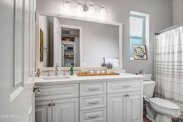 bathroom with a shower with curtain, vanity, and toilet