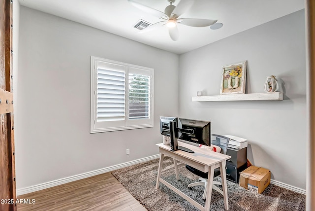 office with hardwood / wood-style floors and ceiling fan