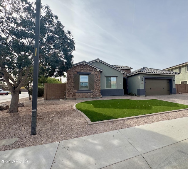 view of front of home featuring a front yard, a garage, and cooling unit