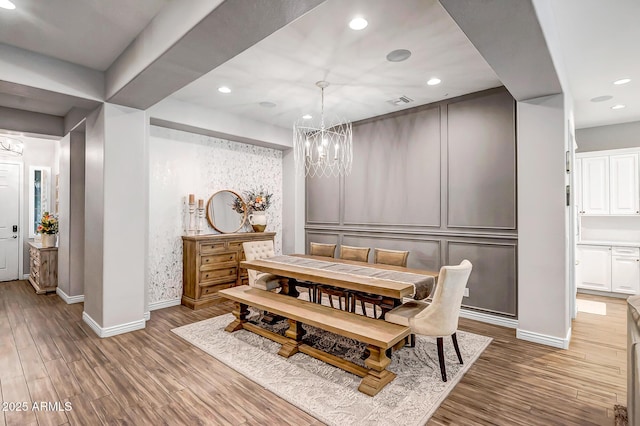 dining room featuring dark wood-type flooring and an inviting chandelier