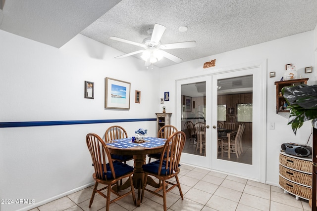 dining area with ceiling fan, light tile patterned floors, a textured ceiling, and french doors