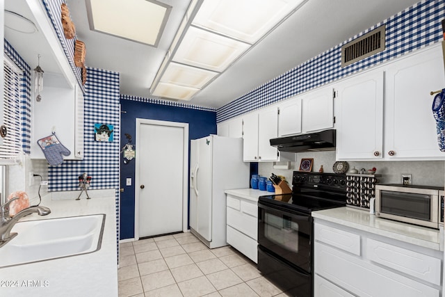 kitchen featuring black electric range oven, white refrigerator with ice dispenser, white cabinets, sink, and light tile patterned floors