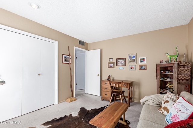 interior space featuring a textured ceiling and light colored carpet