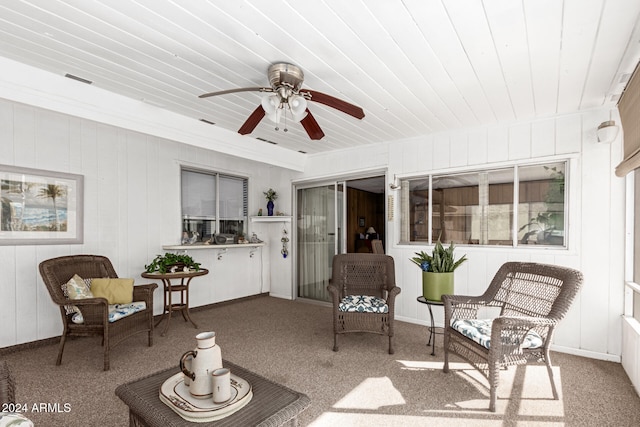 sunroom featuring ceiling fan and wood ceiling