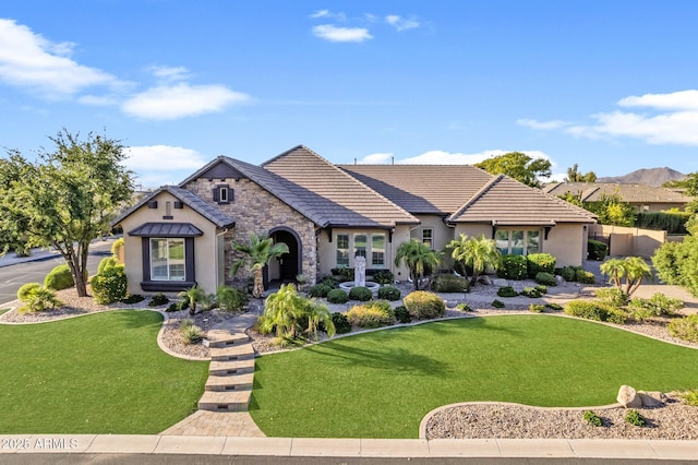 6918 E Ivyglen St, Mesa, AZ 85207 - view of front facade featuring stucco siding, a front yard, stone siding, and a tile roof