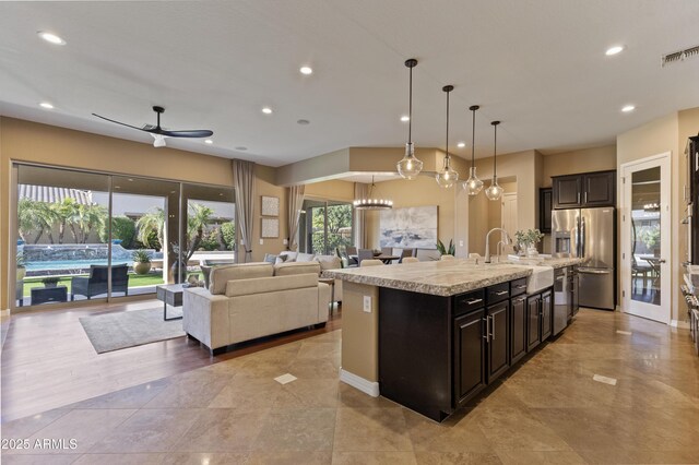 6918 E Ivyglen St, Mesa, AZ 85207 - kitchen featuring appliances with stainless steel finishes, open floor plan, a ceiling fan, an island with sink, and recessed lighting