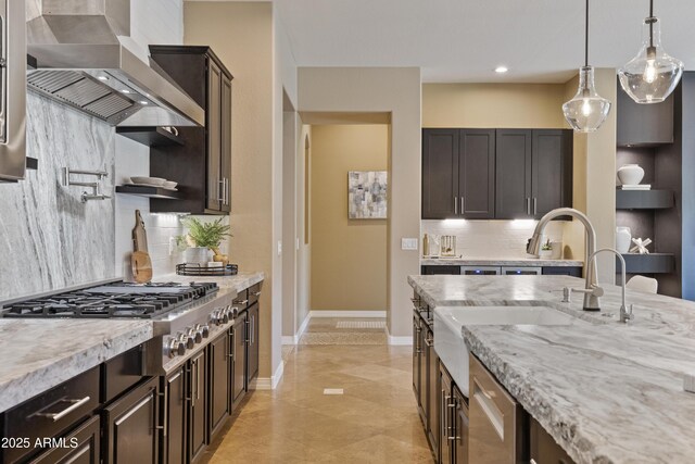 6918 E Ivyglen St, Mesa, AZ 85207 - kitchen with wall chimney exhaust hood, decorative backsplash, hanging light fixtures, stainless steel gas cooktop, and light stone counters