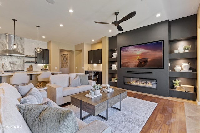 6918 E Ivyglen St, Mesa, AZ 85207 - living room featuring ceiling fan, light wood-style floors, built in features, recessed lighting, and a fireplace