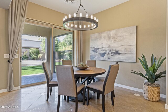 6918 E Ivyglen St, Mesa, AZ 85207 - tiled dining room with a chandelier and baseboards