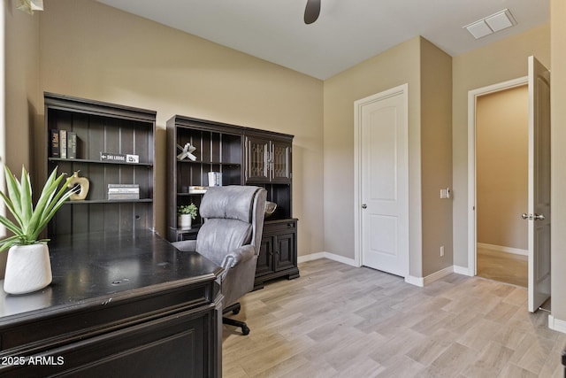 6918 E Ivyglen St, Mesa, AZ 85207 - home office with light wood-style floors, a ceiling fan, and baseboards