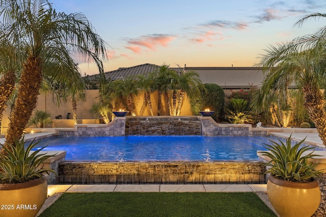6918 E Ivyglen St, Mesa, AZ 85207 - pool at dusk featuring a fenced backyard