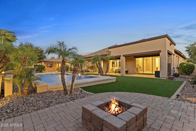 6918 E Ivyglen St, Mesa, AZ 85207 - back of house featuring an outdoor fire pit, a patio area, stucco siding, an outdoor pool, and a yard