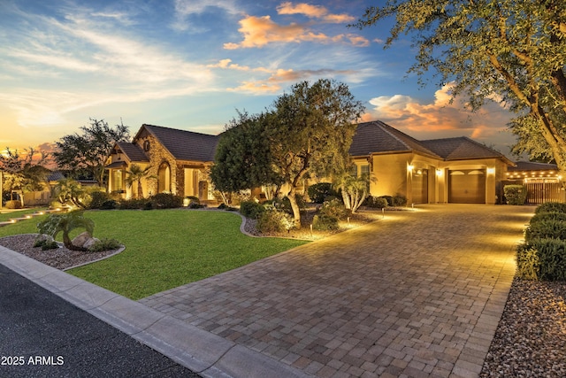 6918 E Ivyglen St, Mesa, AZ 85207 - view of front of house featuring decorative driveway, a tile roof, an attached garage, and stucco siding