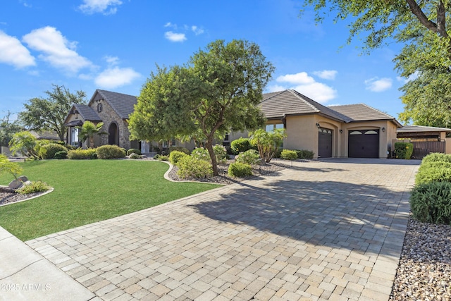 6918 E Ivyglen St, Mesa, AZ 85207 - view of front of house with an attached garage, a front yard, decorative driveway, stucco siding, and a tile roof