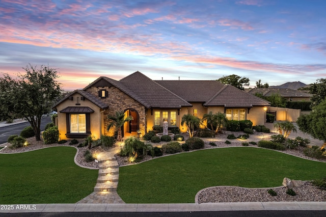 6918 E Ivyglen St, Mesa, AZ 85207 - view of front facade featuring stucco siding, a front yard, stone siding, and a tile roof