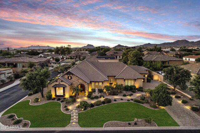 6918 E Ivyglen St, Mesa, AZ 85207 - view of front of property with a tile roof, stucco siding, a residential view, and a lawn