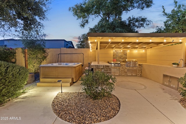 6918 E Ivyglen St, Mesa, AZ 85207 - patio terrace at dusk with a hot tub, a sink, and a patio area
