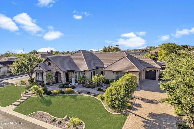 6918 E Ivyglen St, Mesa, AZ 85207 - view of front of property with stone siding, stucco siding, decorative driveway, an attached garage, and a front yard