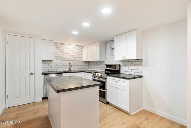 kitchen featuring a center island, white cabinets, stainless steel appliances, and light hardwood / wood-style floors