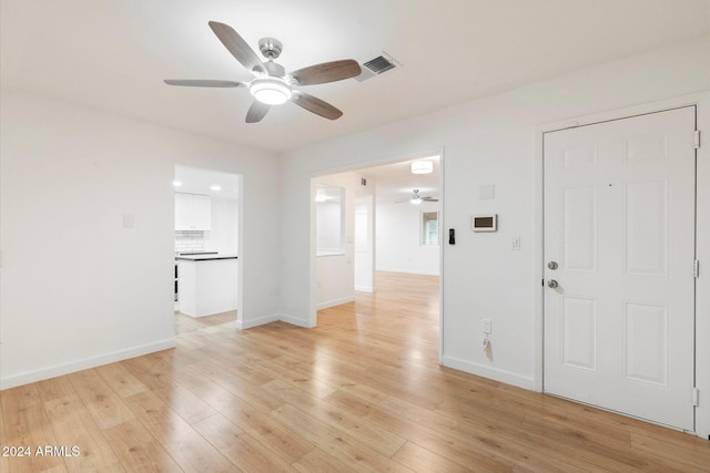 empty room featuring light hardwood / wood-style flooring and ceiling fan