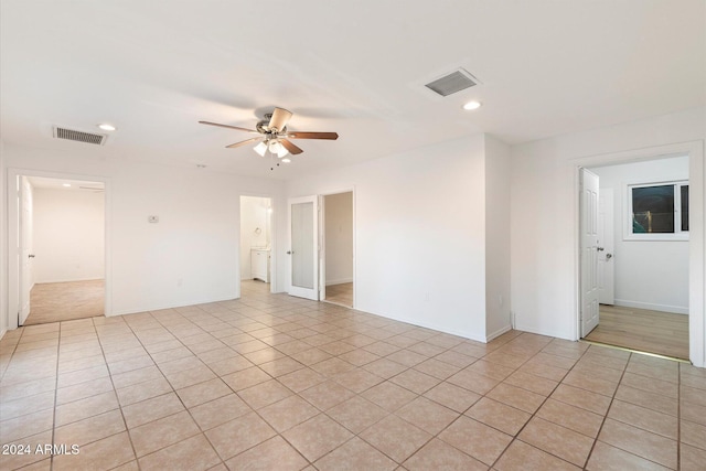 empty room featuring ceiling fan and light tile patterned floors