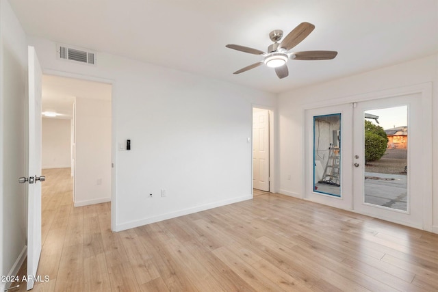 unfurnished room with french doors, light hardwood / wood-style flooring, and ceiling fan