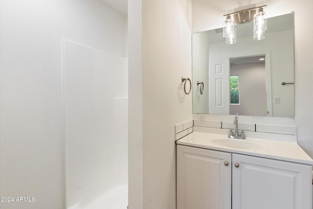 bathroom with vanity and walk in shower