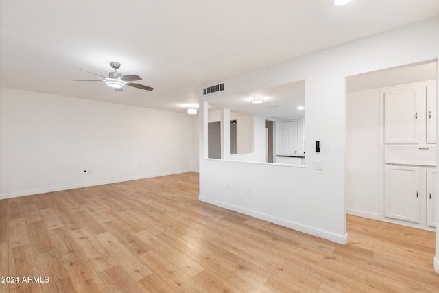 unfurnished room with ceiling fan and light wood-type flooring