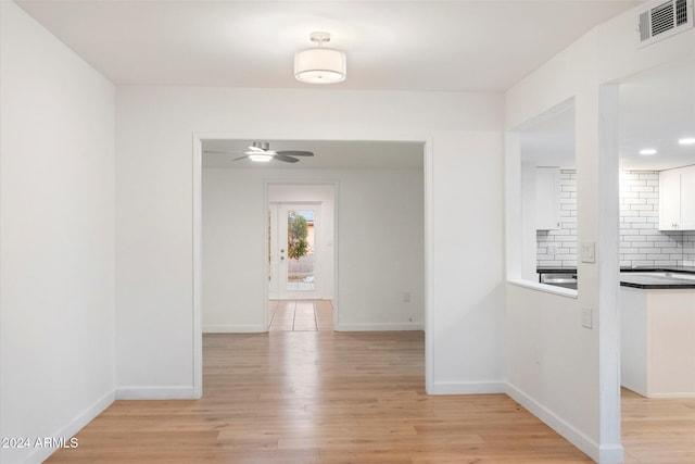 hall with light wood-type flooring