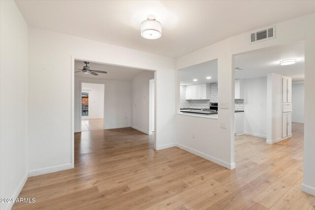 interior space with ceiling fan and light hardwood / wood-style flooring