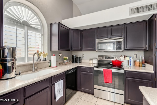 kitchen featuring appliances with stainless steel finishes, a sink, light countertops, light tile patterned floors, and visible vents