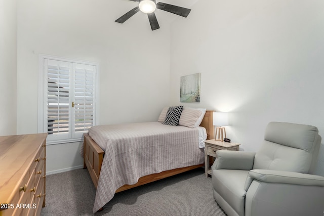 bedroom with carpet flooring, a ceiling fan, a high ceiling, and baseboards