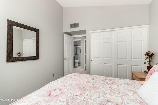 bedroom with visible vents, high vaulted ceiling, tile patterned floors, and a closet