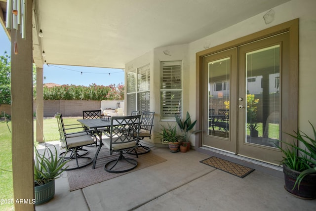 view of patio / terrace featuring outdoor dining area, fence, and french doors