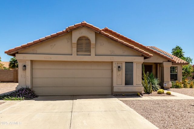 view of front of house with an attached garage, stucco siding, and driveway