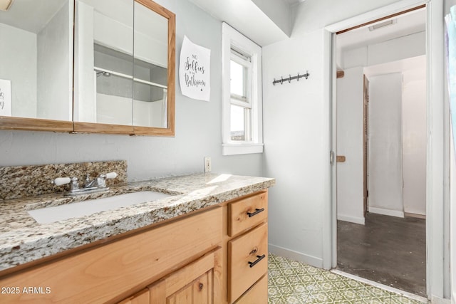 bathroom featuring vanity, visible vents, and baseboards