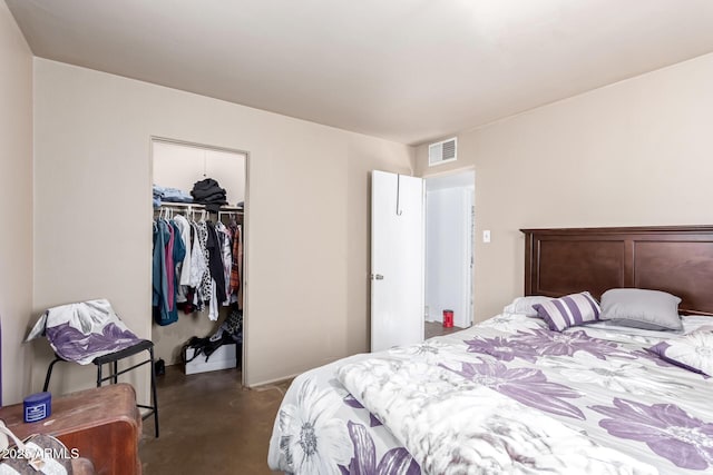 bedroom featuring visible vents, a closet, finished concrete floors, and a spacious closet