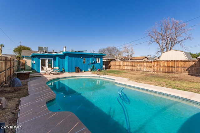 view of pool featuring a patio, a fenced in pool, a lawn, and a fenced backyard